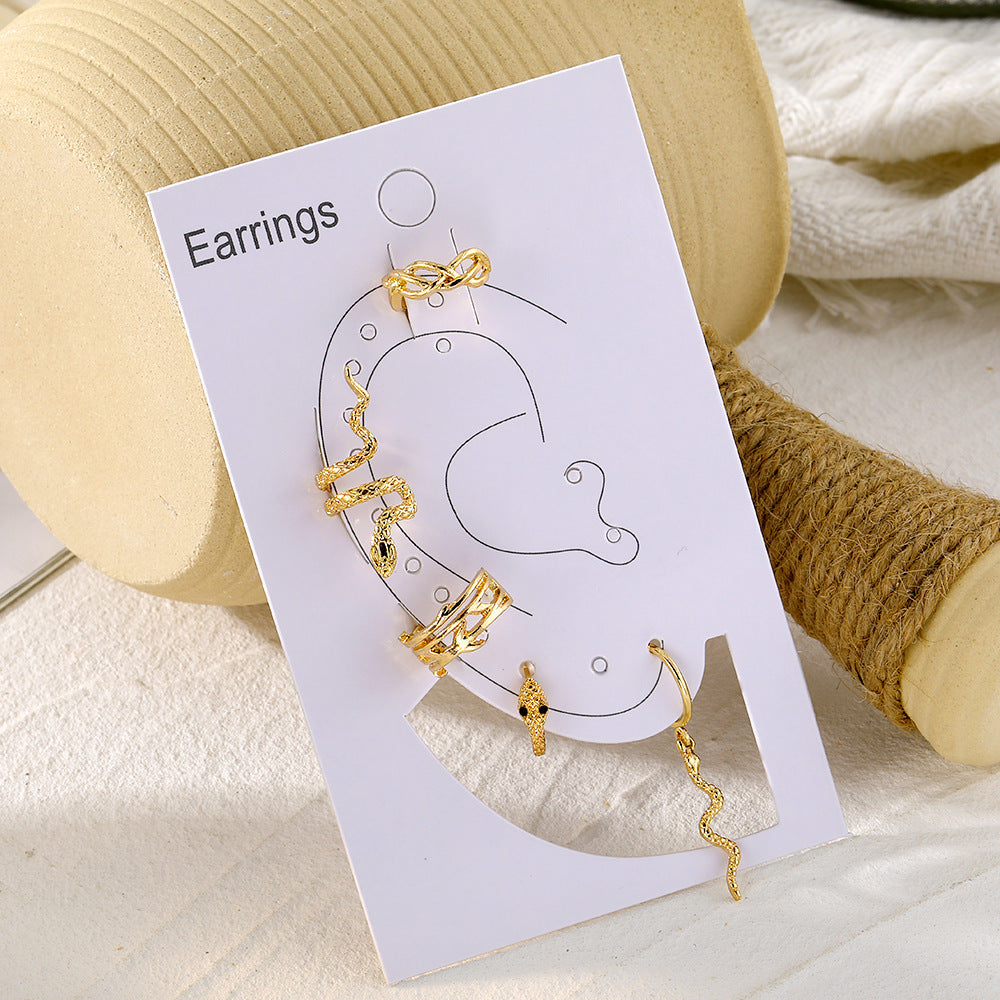 a paper with gold earrings on it