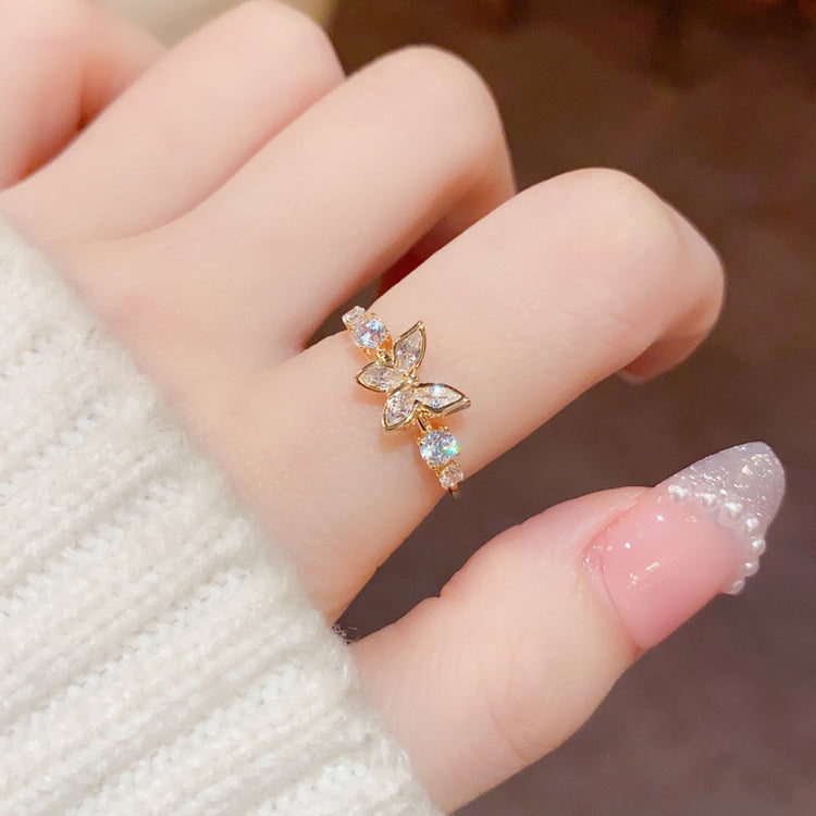 a hand wearing a gold ring
