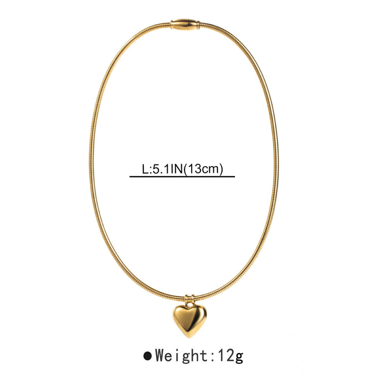a gold necklace with a heart pendant