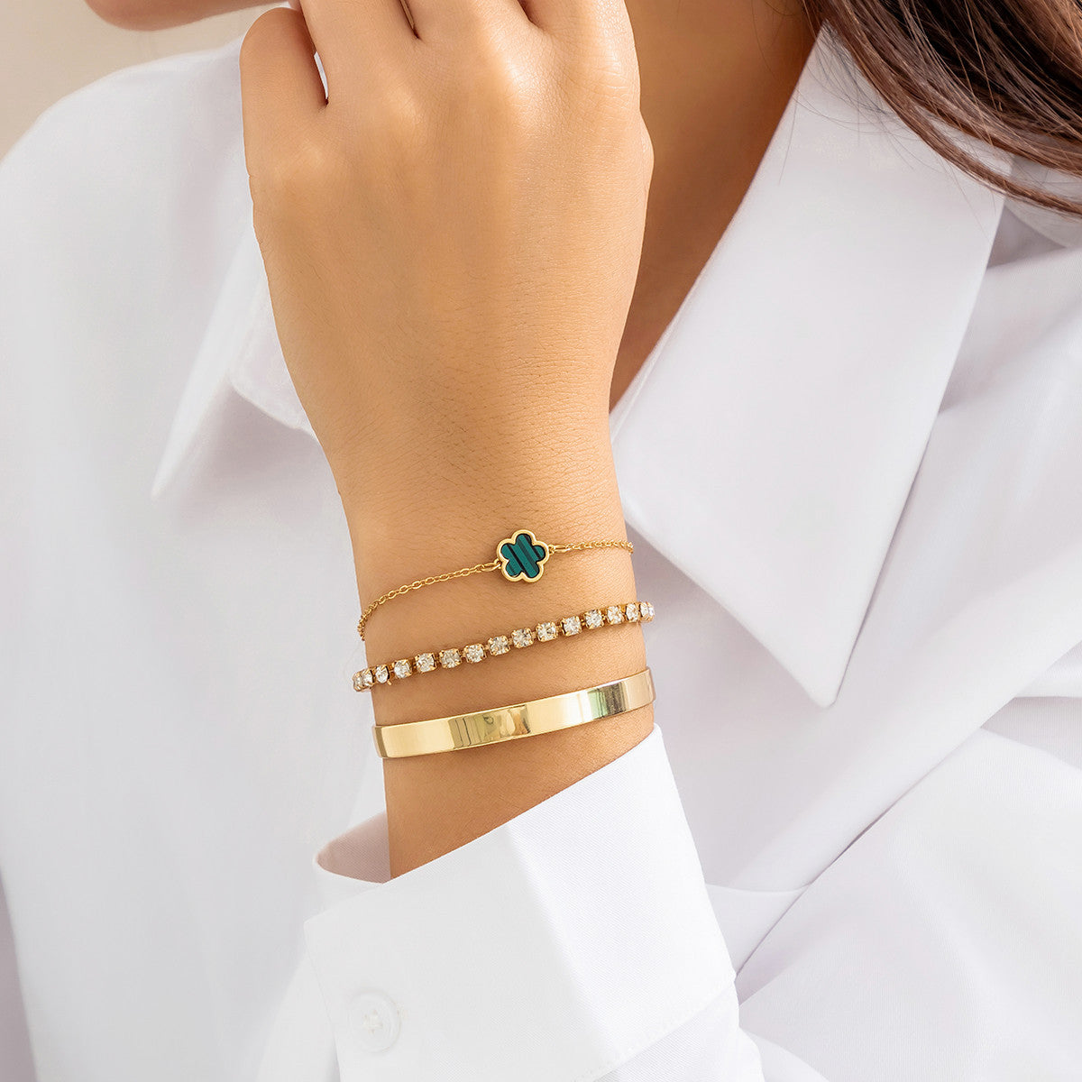 a woman wearing a white shirt and bracelets