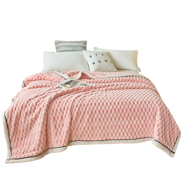 a pink blanket on a bed
