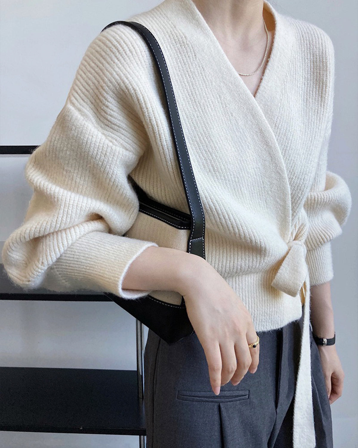a woman wearing a white sweater