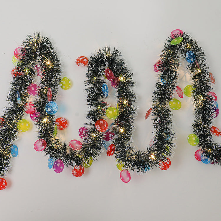 a black tinsel with lights and candy