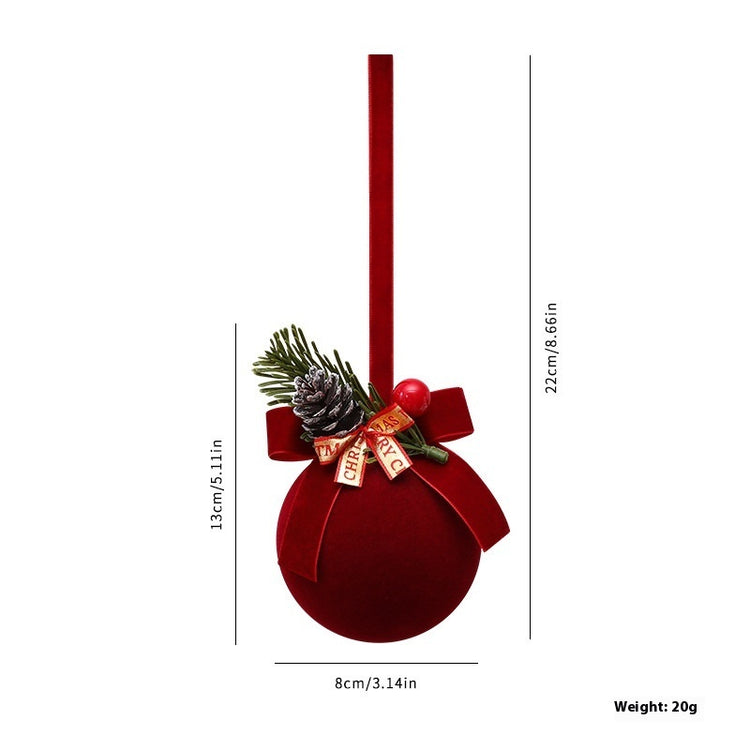 a red christmas ornament with a pine cone and a ribbon