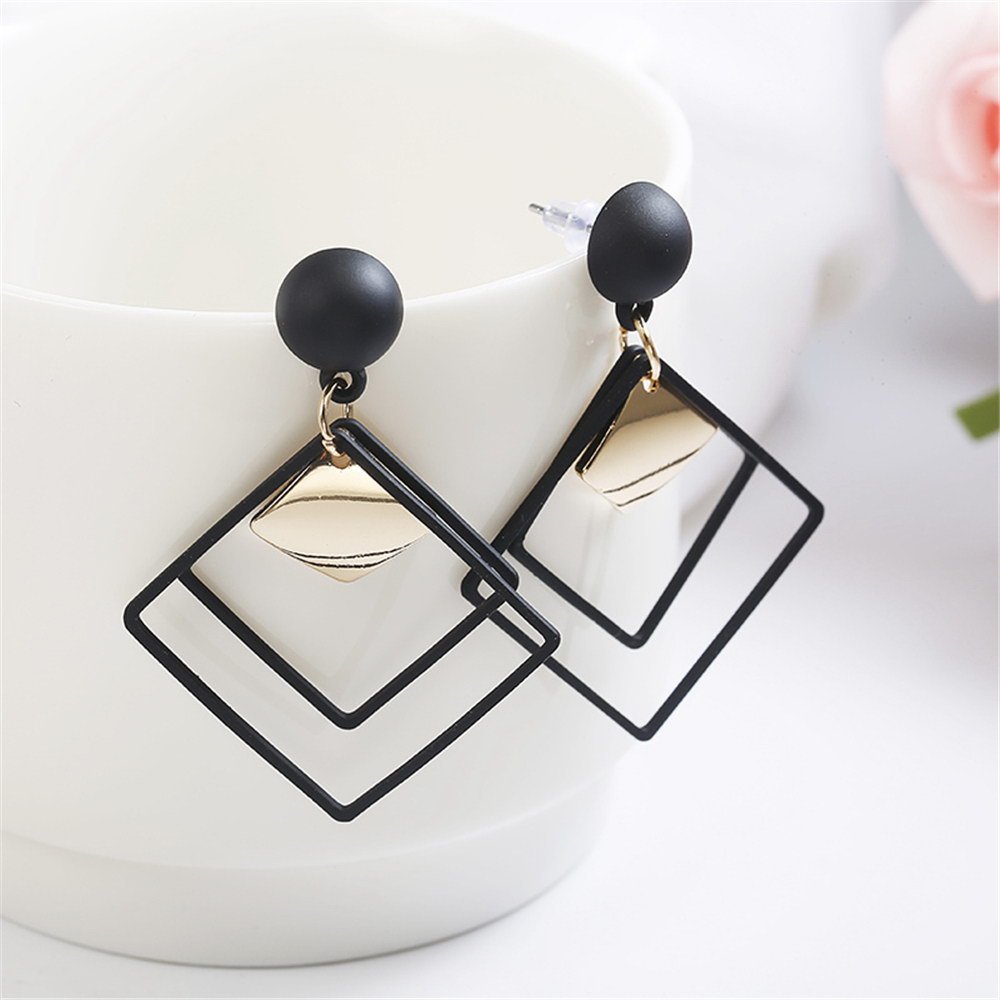 a pair of black square earrings