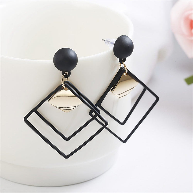 a pair of black square earrings