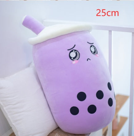 a purple soft toy with a sad face