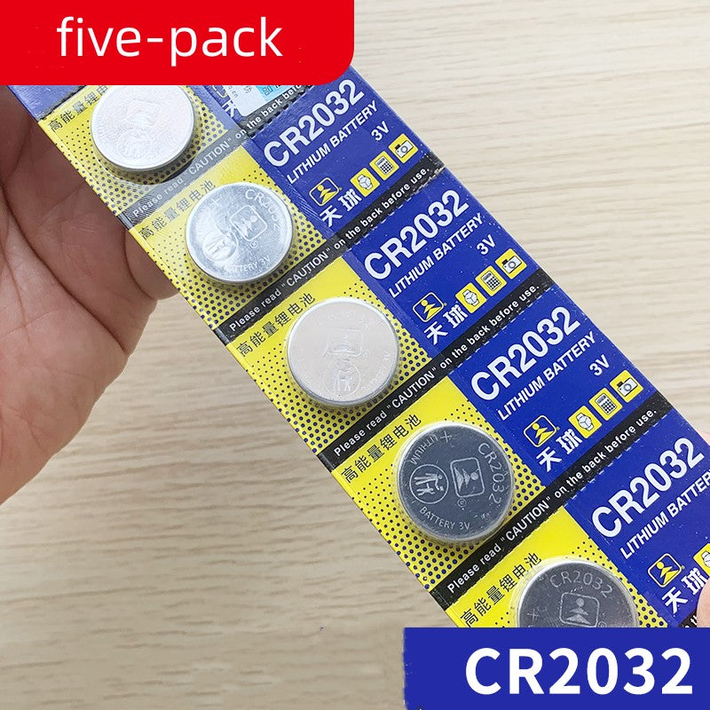 a hand holding a pack of batteries