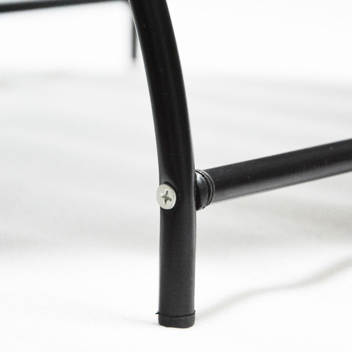 a close up of a black metal leg