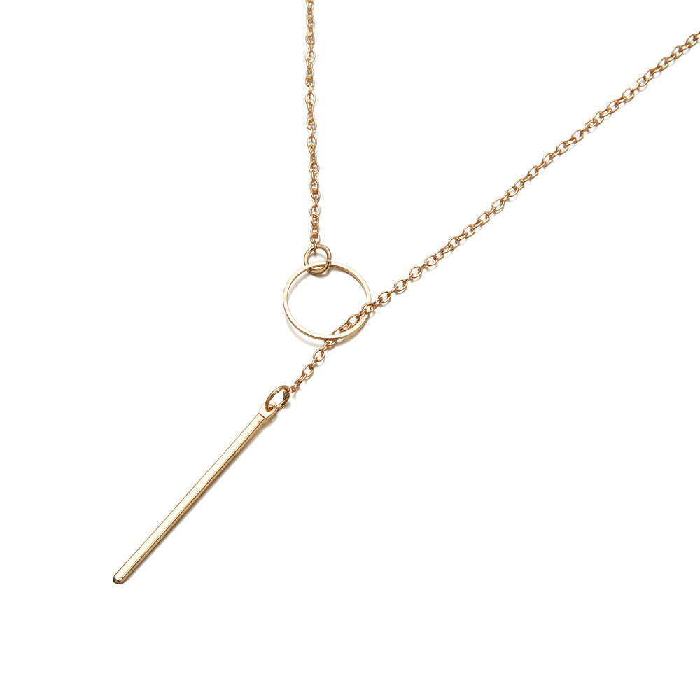a gold necklace with a bar on it