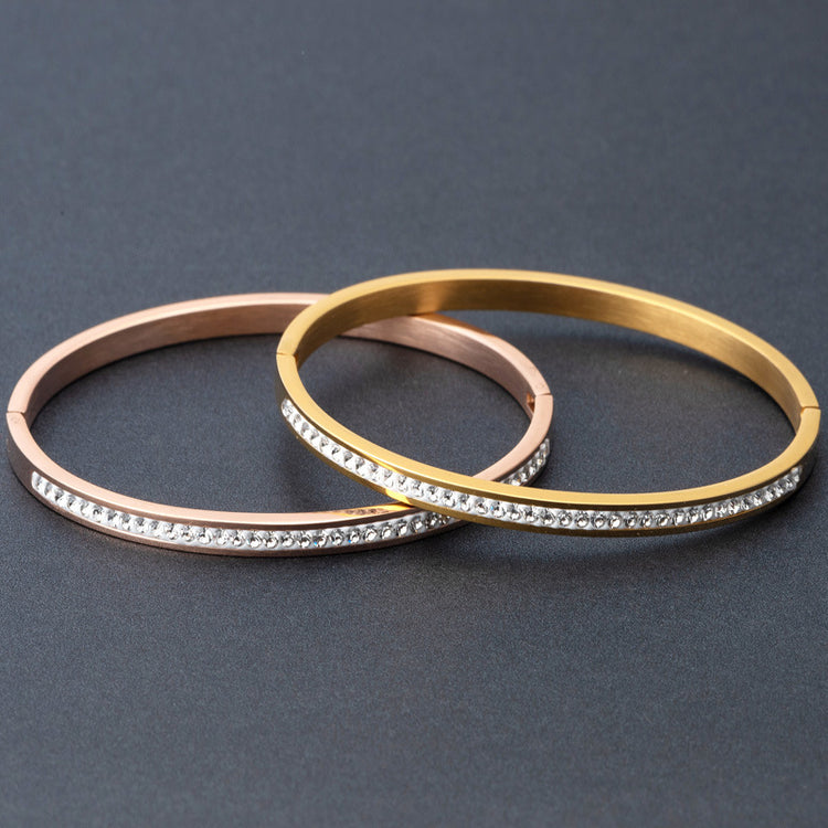 a group of gold and silver bracelets