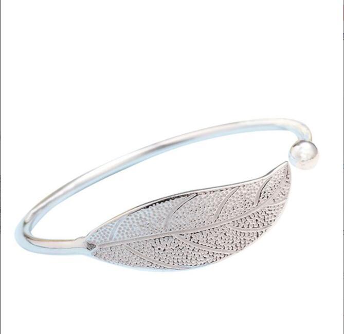 a silver leaf bracelet with a pearl