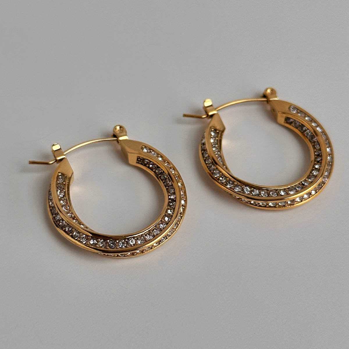 a pair of gold hoop earrings