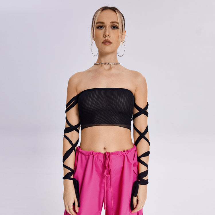 a woman in a black top and pink pants