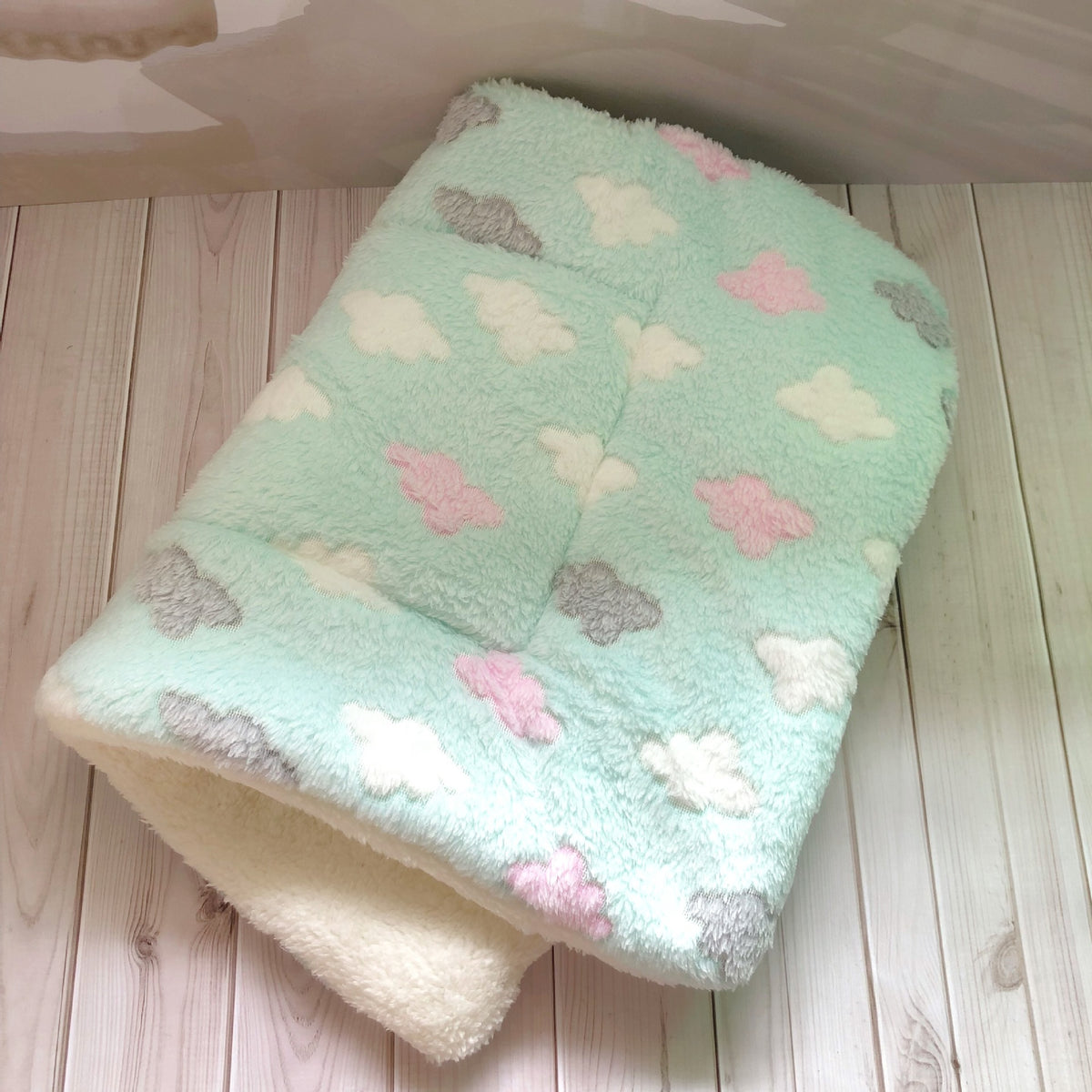 a blanket on a wood surface