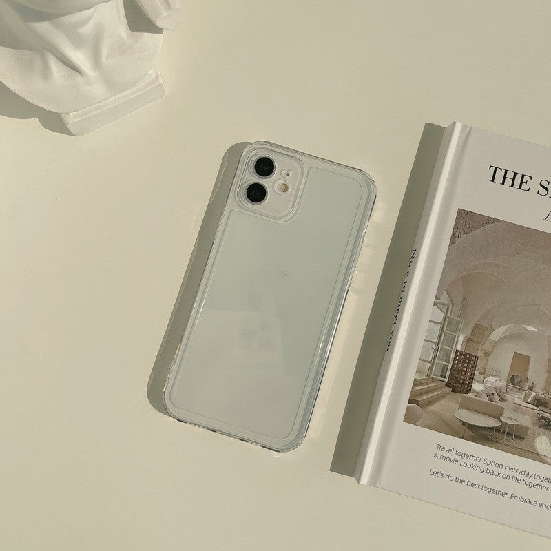 a white phone next to a book