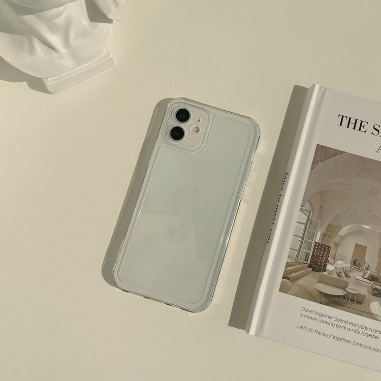 a white phone next to a book