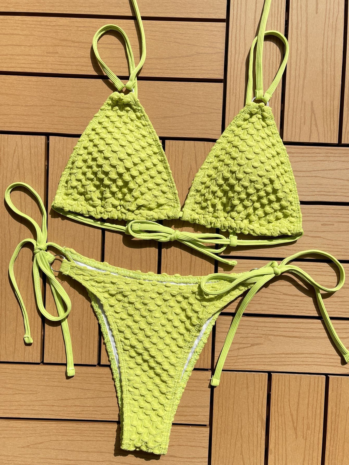 a green garment on a wood surface
