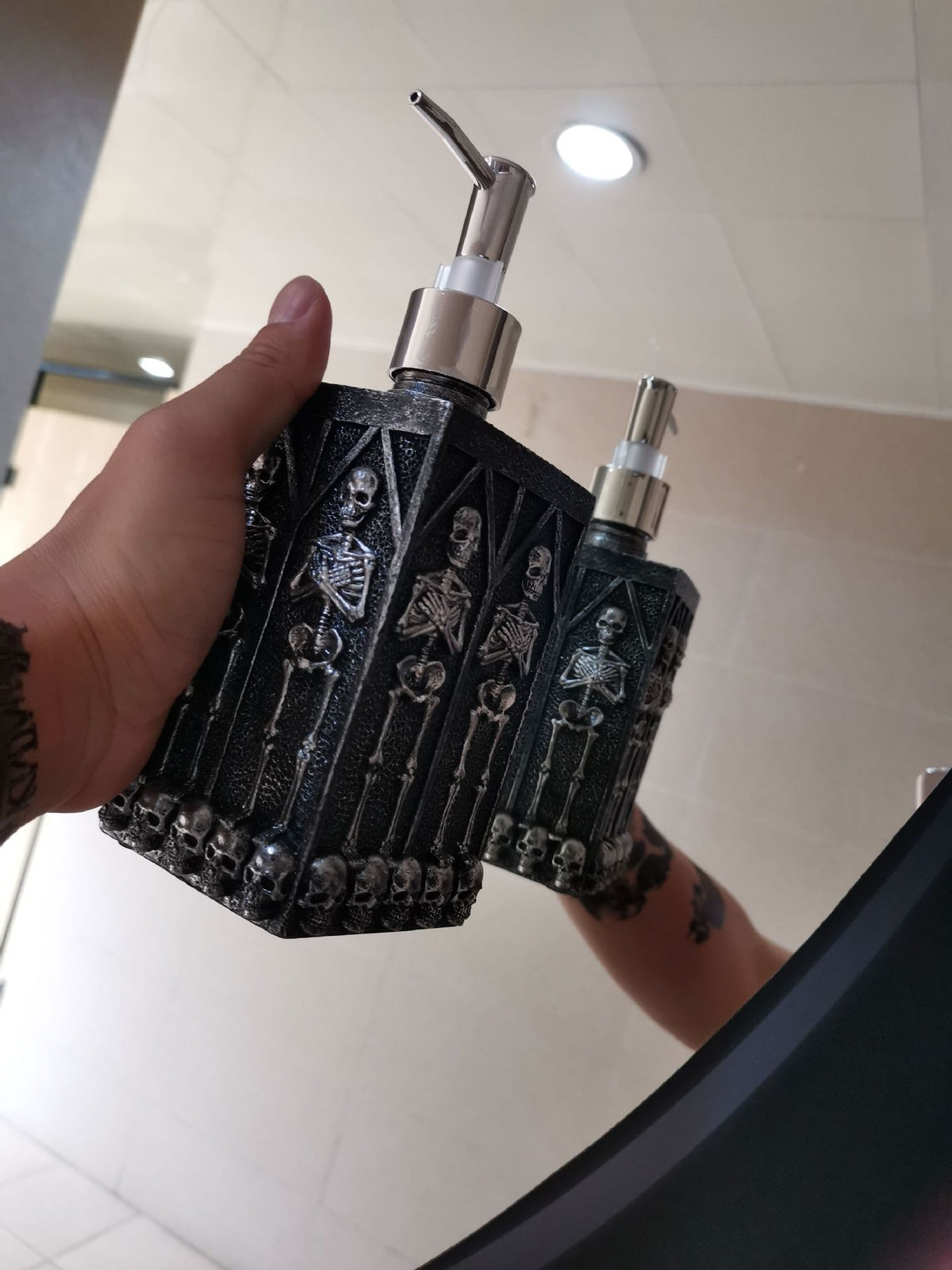 a hand holding a bottle of liquid