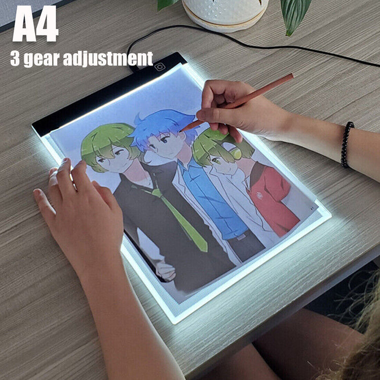 a person drawing on a light board