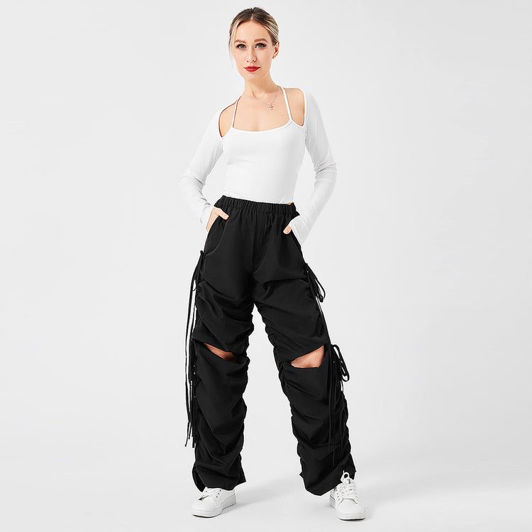 a woman in a white shirt and black pants