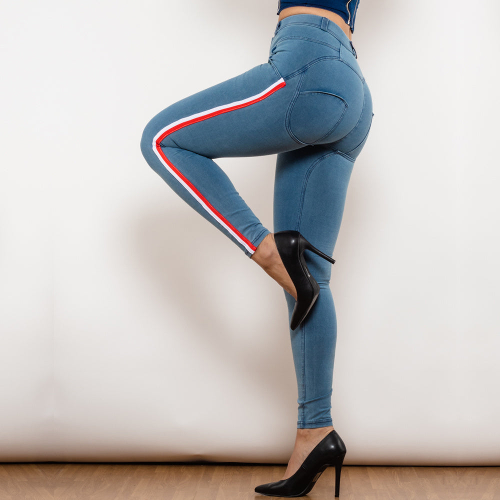 a woman wearing blue jeans and black high heels