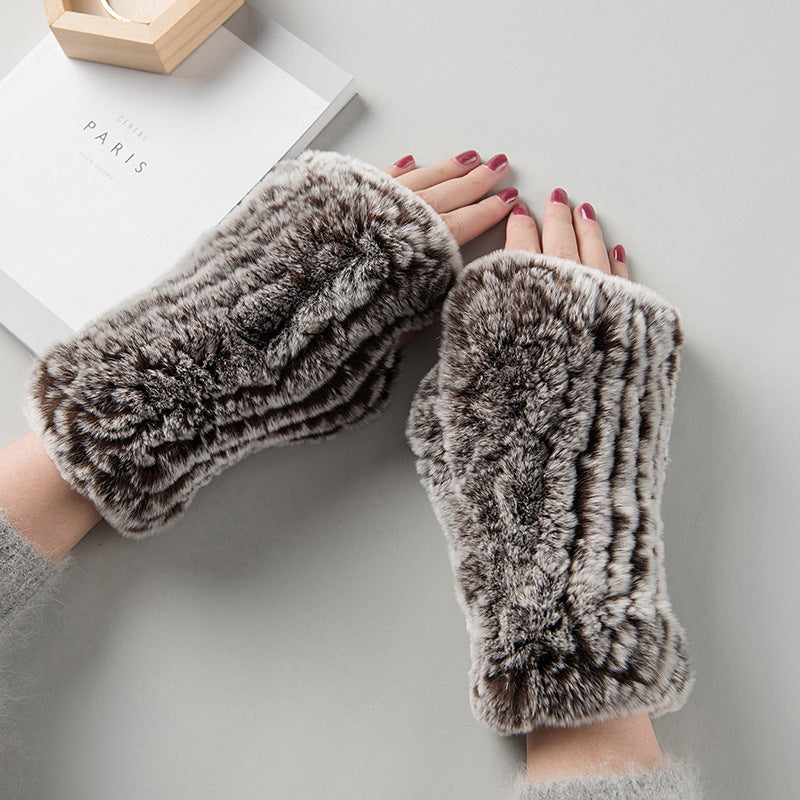 a pair of hands wearing furry gloves