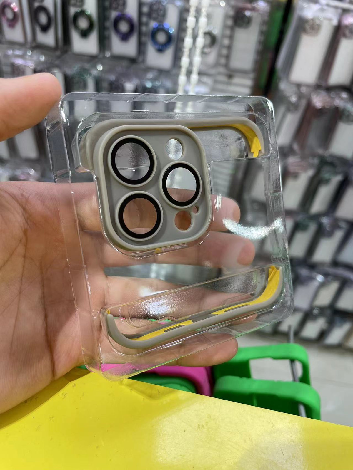 a hand holding a plastic case with multiple circles