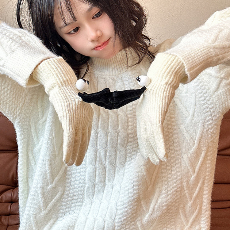 a girl wearing white sweater and gloves