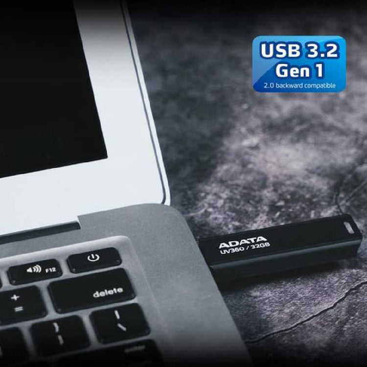a laptop next to a usb stick