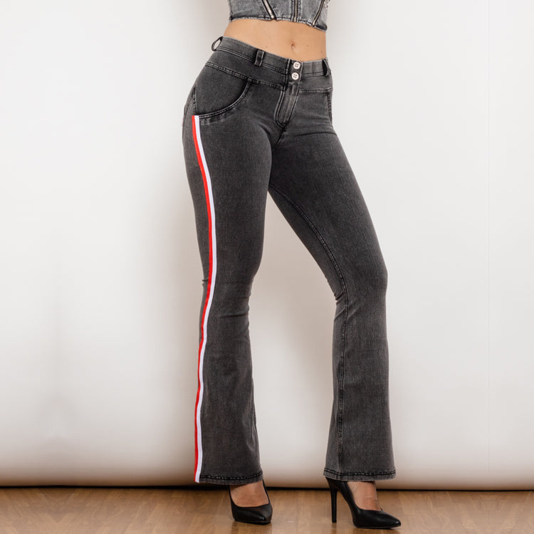 a woman wearing black jeans and a crop top
