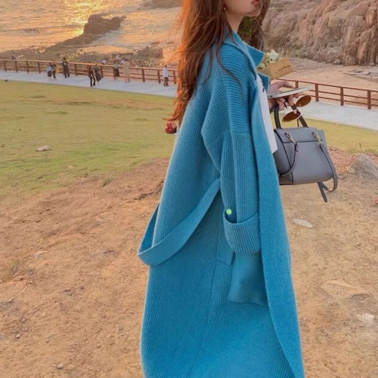 a woman in a long blue coat
