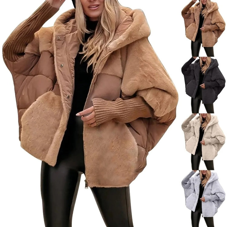 a woman wearing a hat and a large coat
