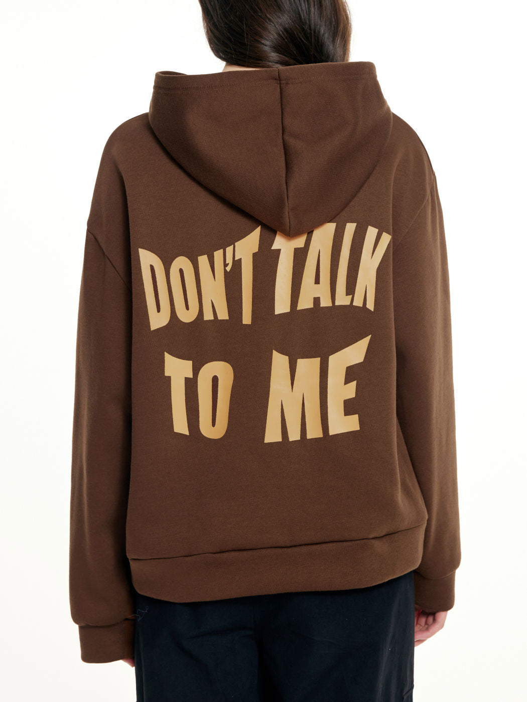 a person wearing a brown hoodie with a brown text on it