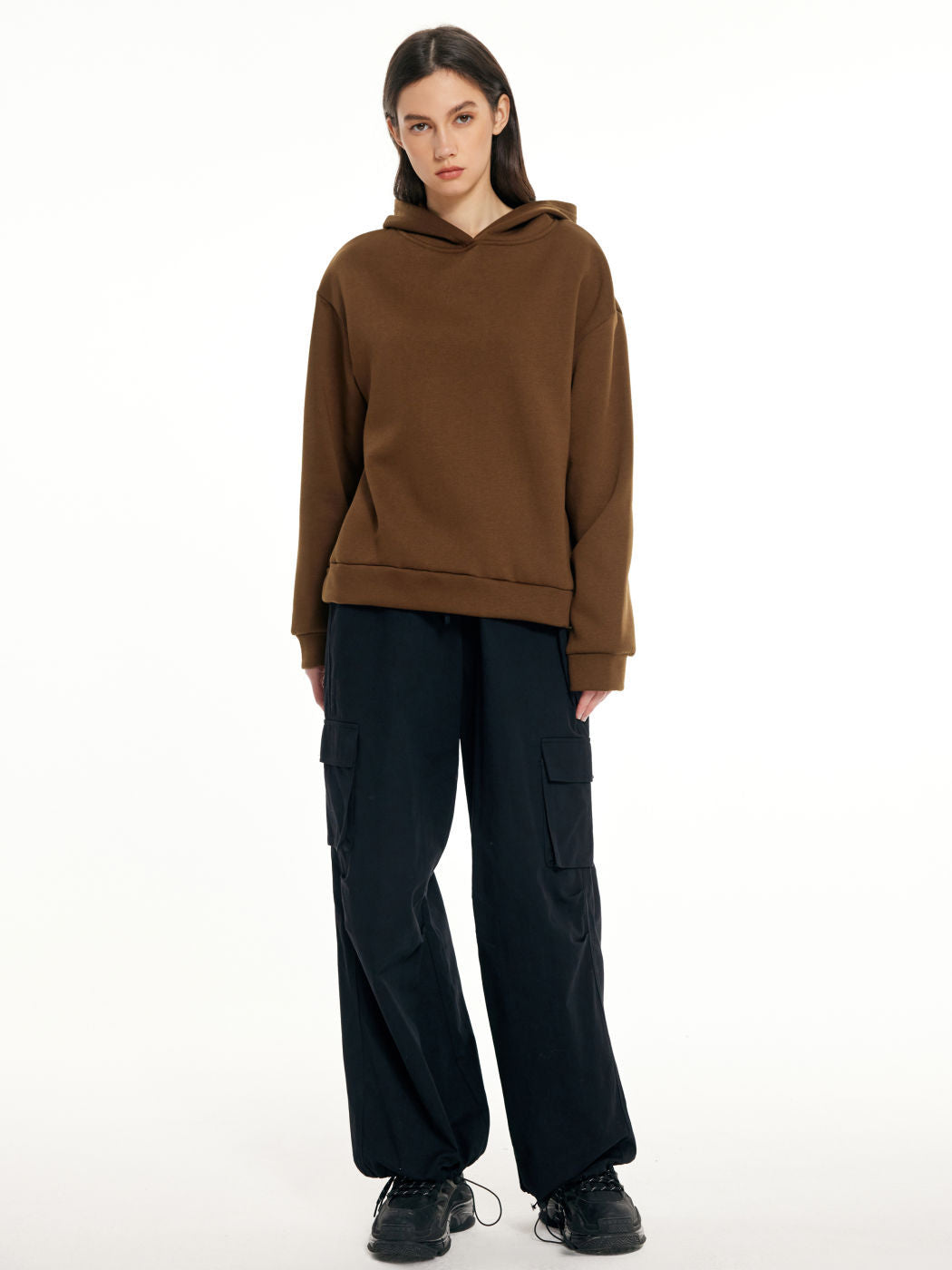 a woman in a brown hoodie