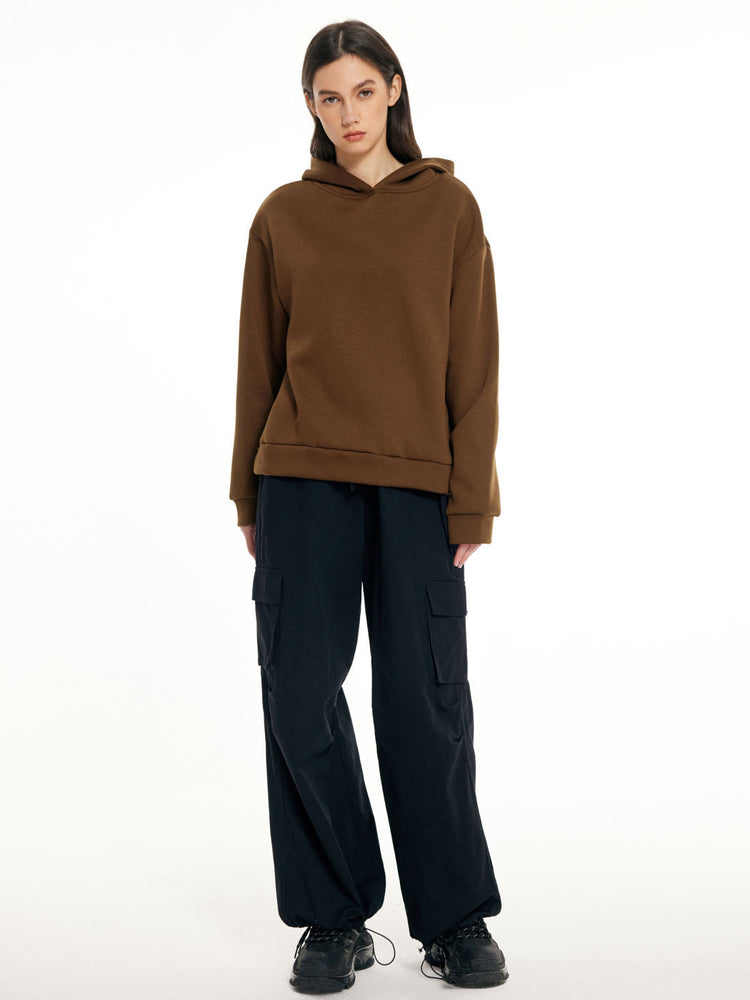 a woman in a brown hoodie