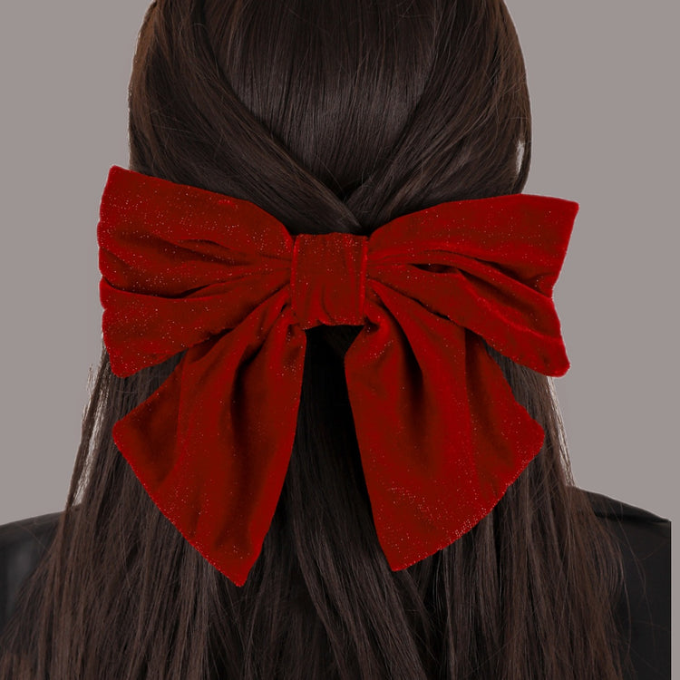 a woman with a red bow in her hair