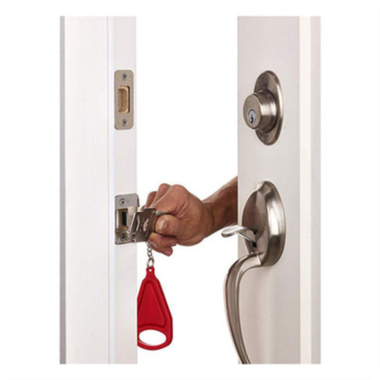 a hand holding a key to a door lock