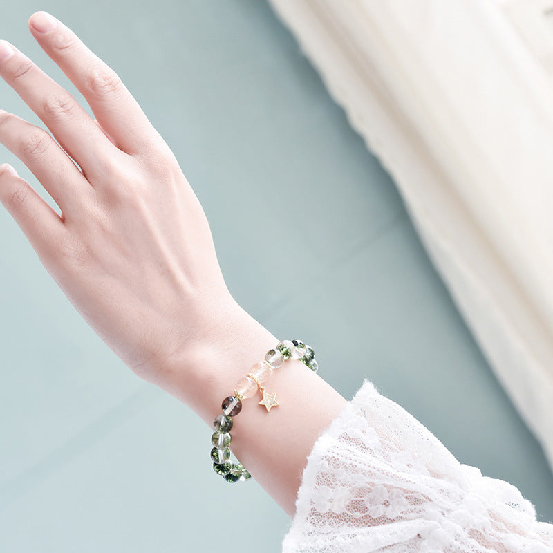 a hand with a bracelet on it
