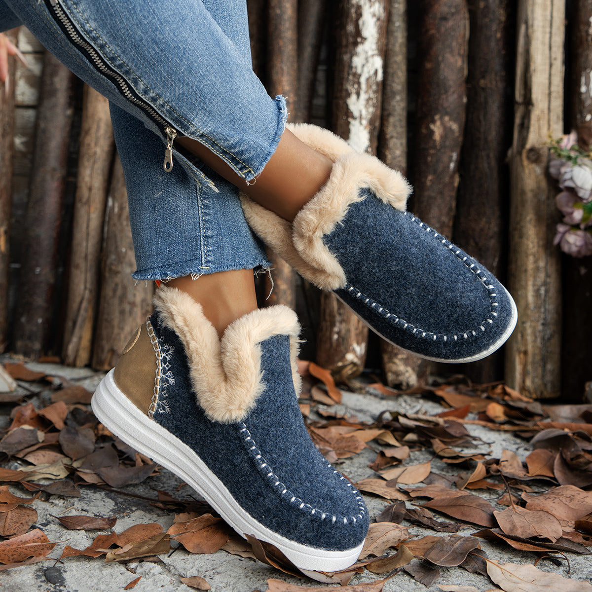 a person wearing blue jeans and slippers
