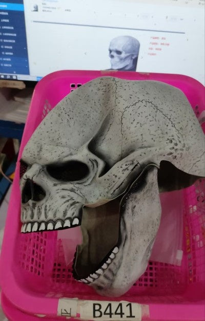 a plastic skull in a pink basket
