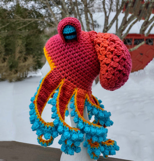 a knitted octopus hat on a mannequin