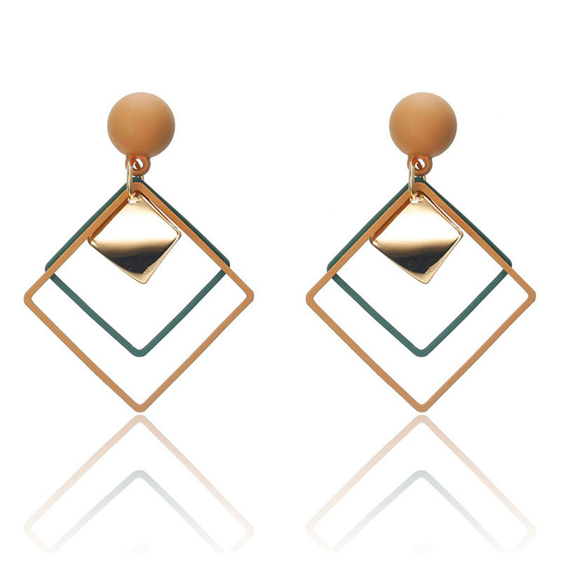 a pair of earrings with a square shape