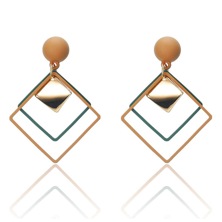 a pair of earrings with a square shape