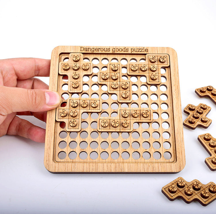 a hand holding a wooden board with holes