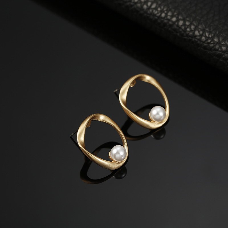 a pair of gold earrings with pearls