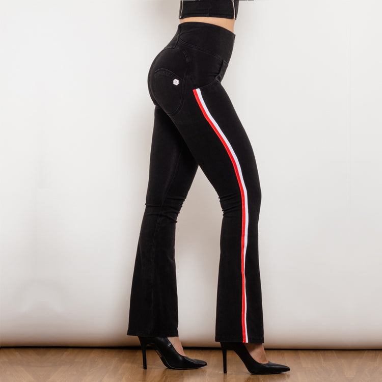 a woman wearing black pants with white stripe on the side
