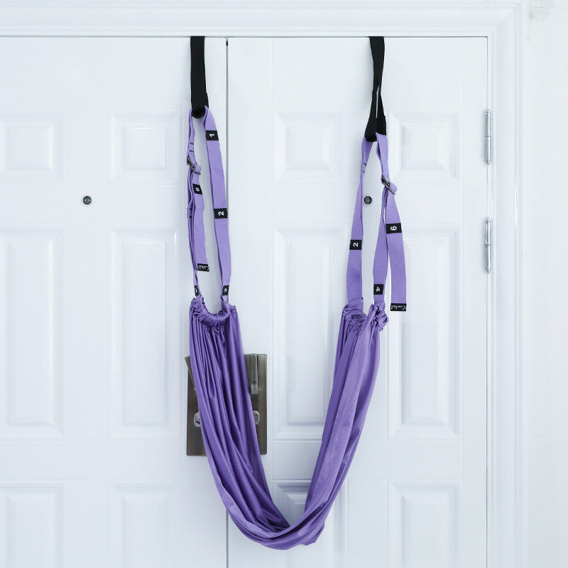 a purple hammock on a white door