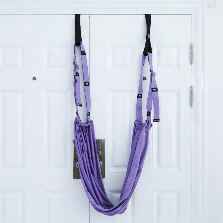 a purple hammock on a white door