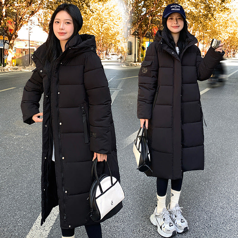 a woman in a long black coat
